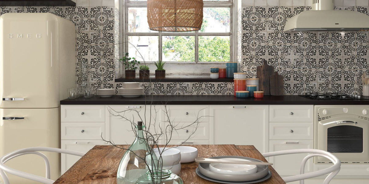 Traditionally inspired kitchen with patterned mosaic splashback wall tiles and cream and white cabinets.