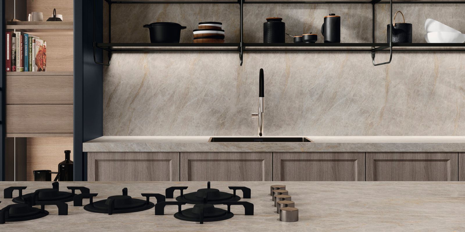 Beige sandy modern kitchen with marble effect wall tiles and black fixtures.