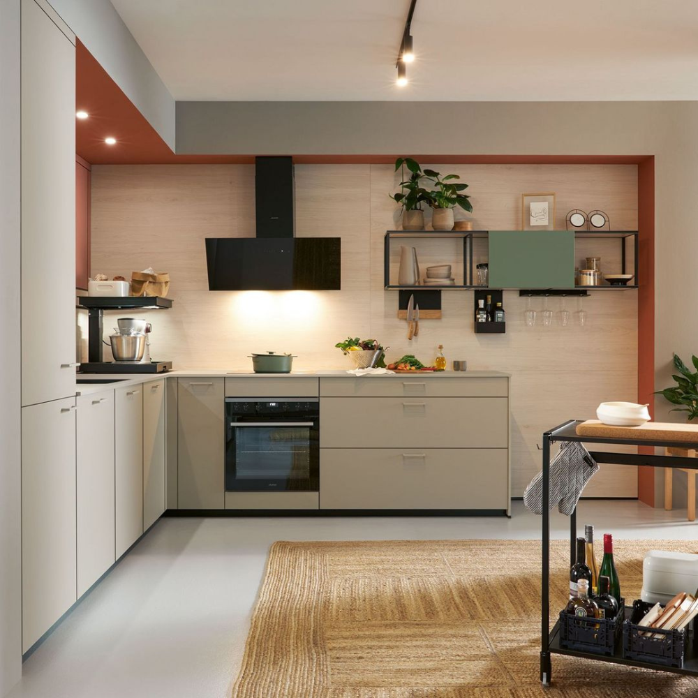Modern kitchen with neutral tones and a rug on the floor.