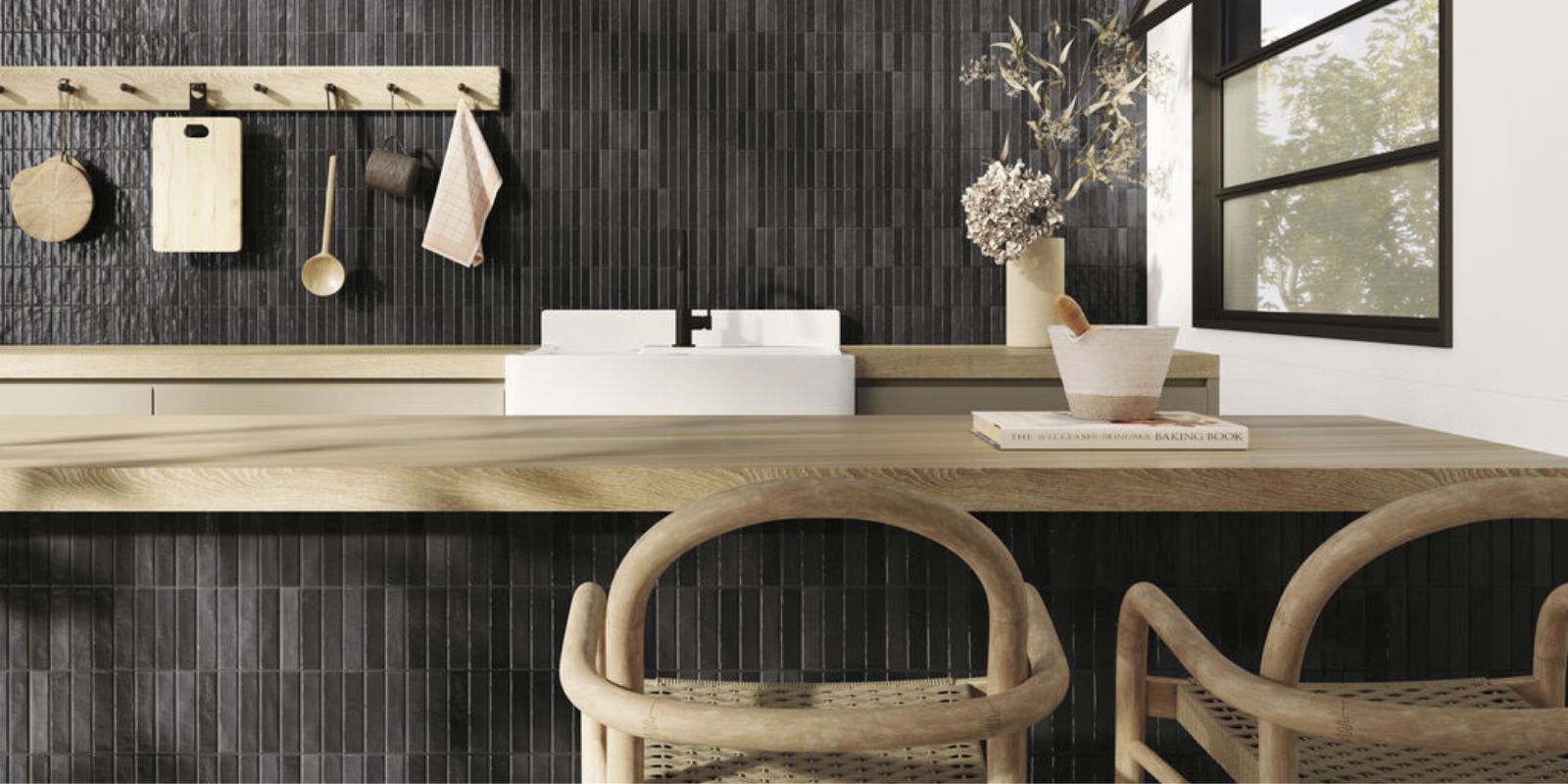 black sleek kitchen with black small subway tiles vertically stacked and cool wood countertops