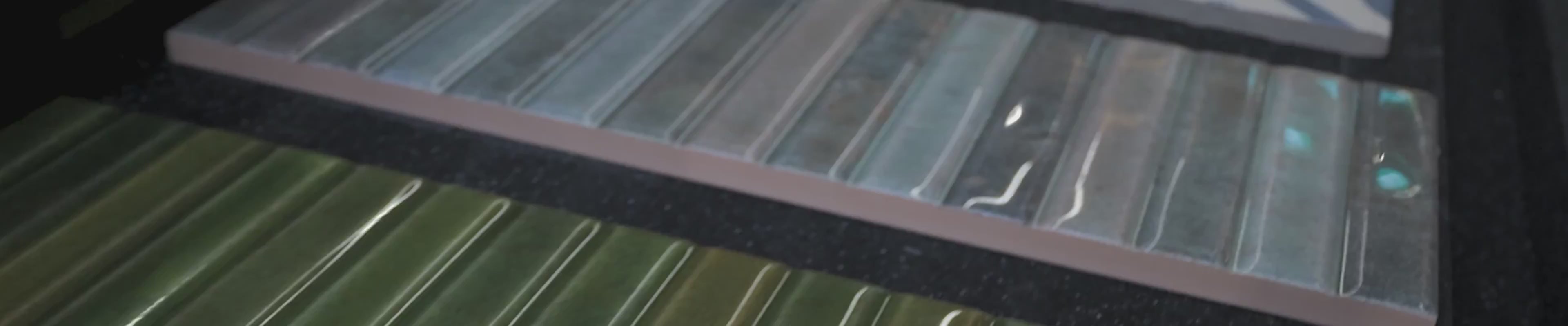 Load video: Tile samples in a box showing the finish and texture.