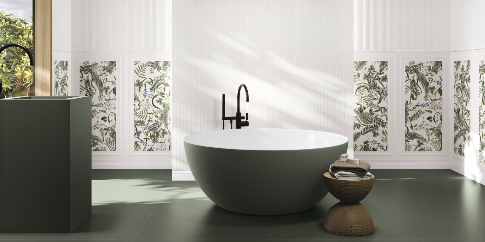 earthy green inspired bathroom with dark green floor tiles and freestanding bathtub