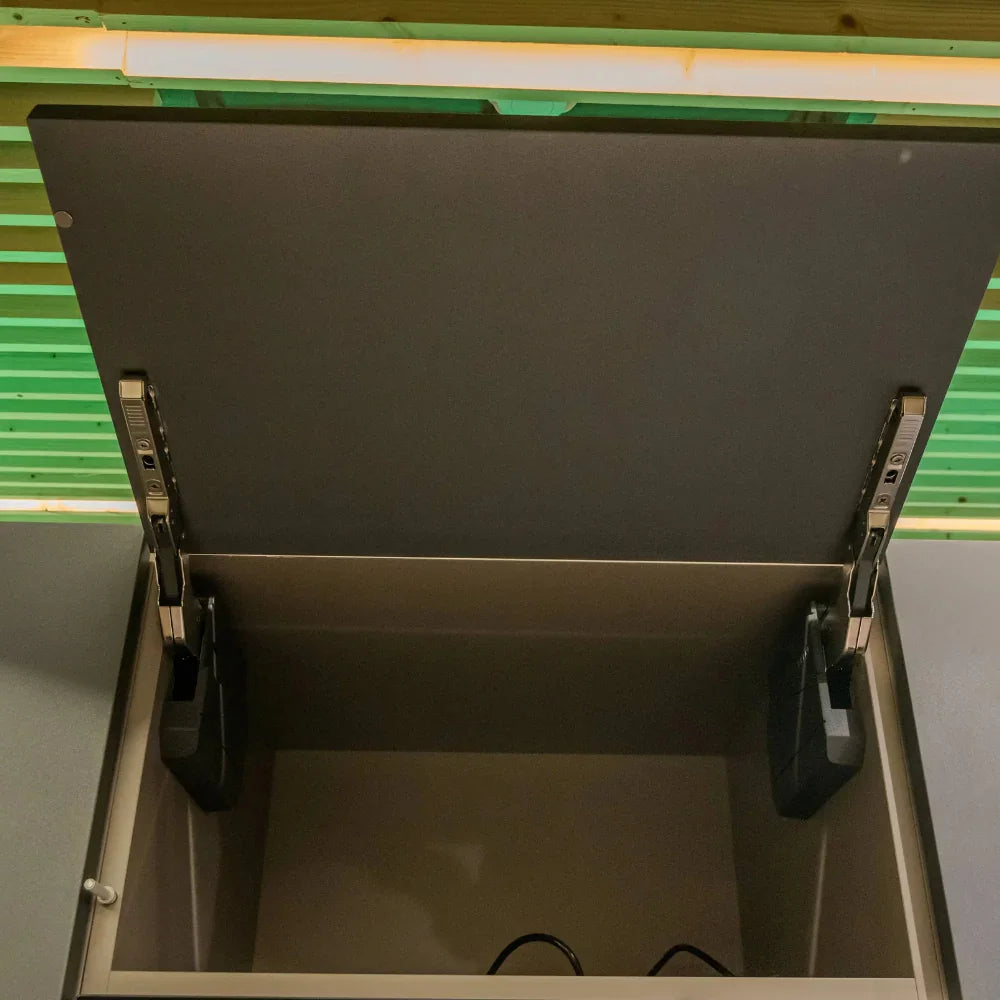 Open grey drawer with metal handles on a green and grey background
