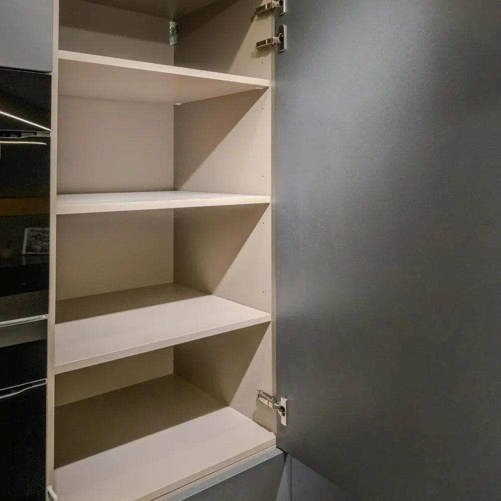 Open cabinet door with multiple shelves.