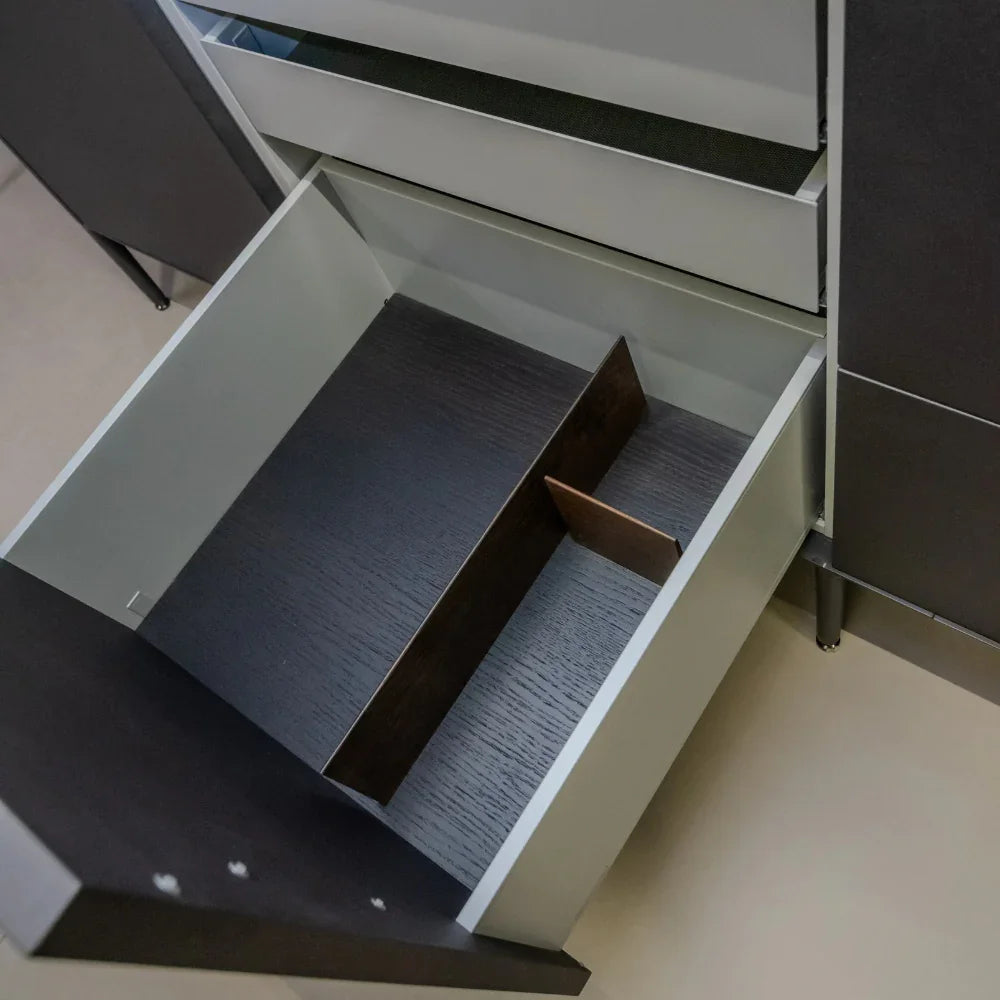 Open drawer with a textured interior on a light-colored floor.