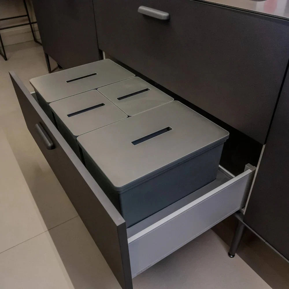 Set of grey storage boxes in an open drawer