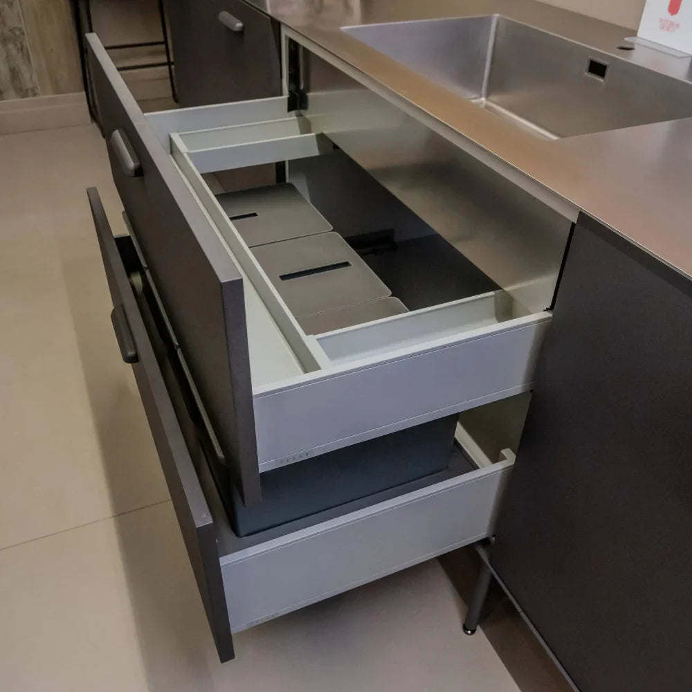 Open kitchen drawer with compartments in a modern kitchen setting