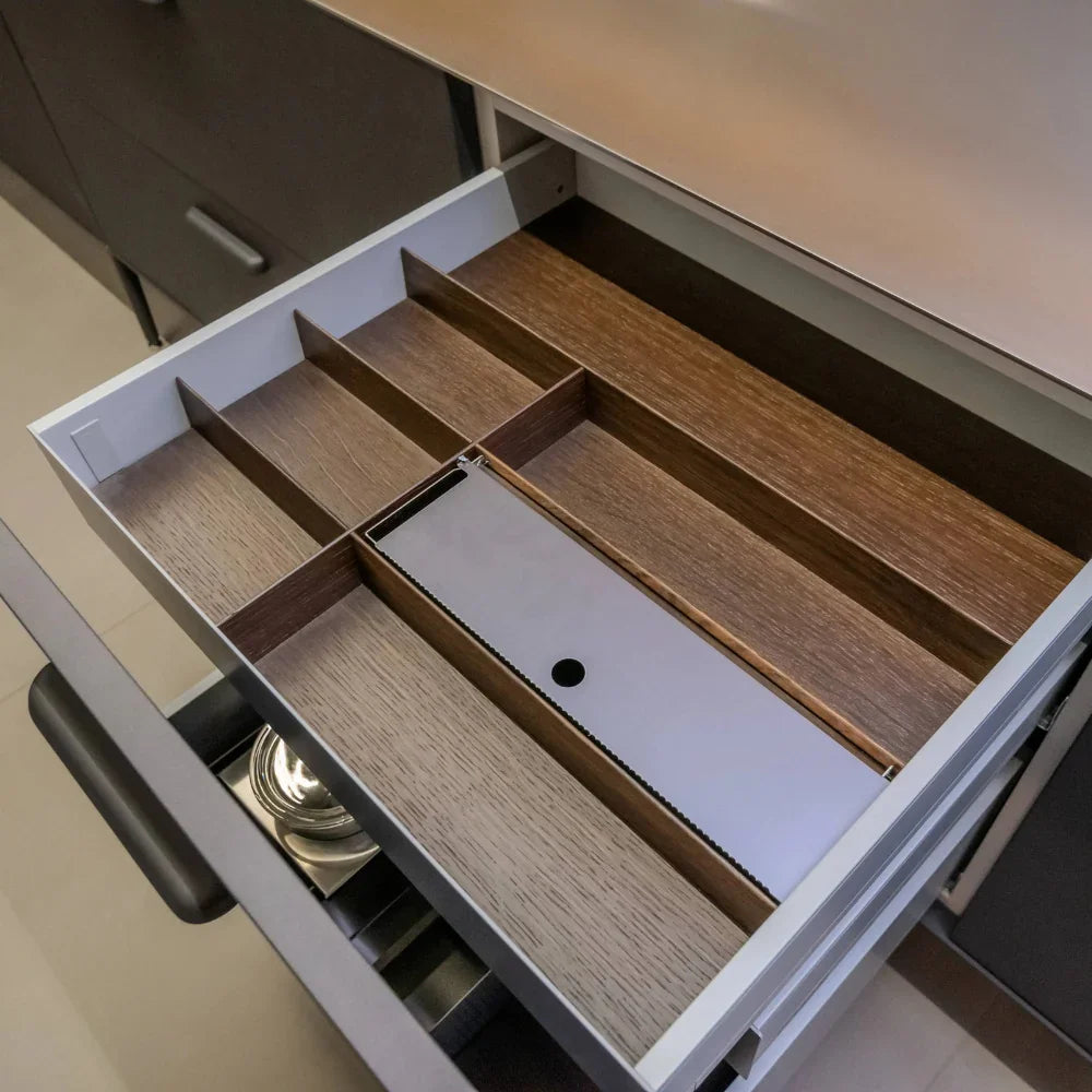 Open drawer with wooden interior and compartments