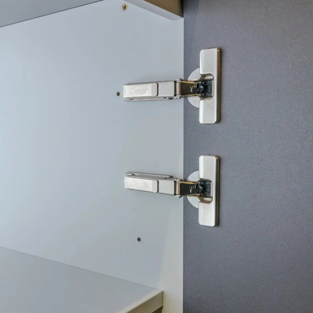 Close-up of a door hinge on a grey wall