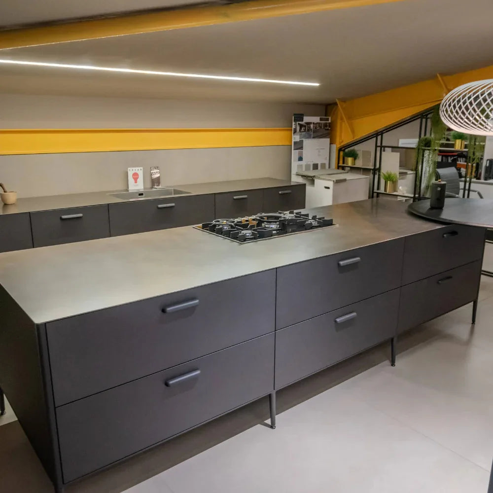 Modern kitchen with grey cabinets, yellow accents, and a central island.