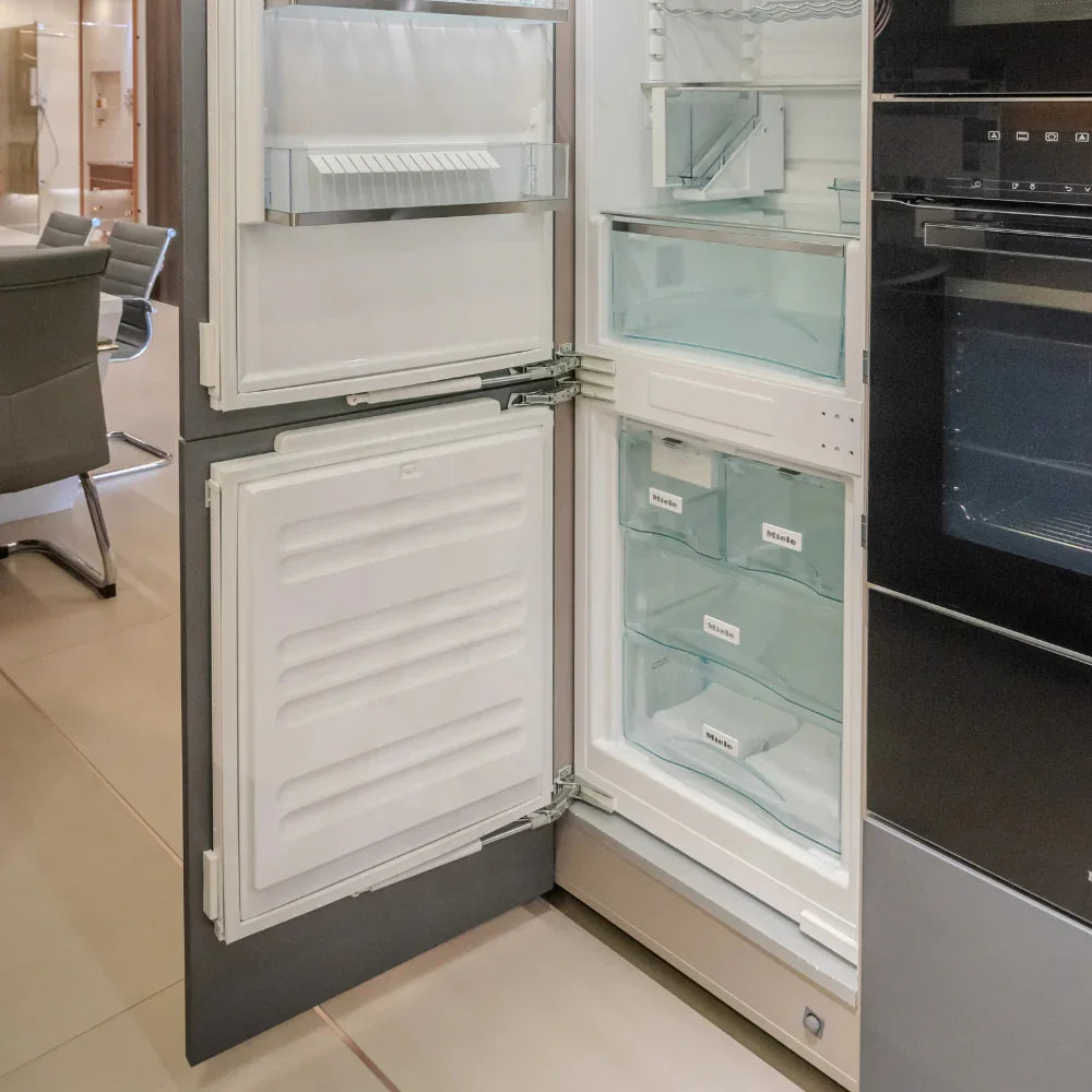 Modern kitchen with open refrigerator and oven