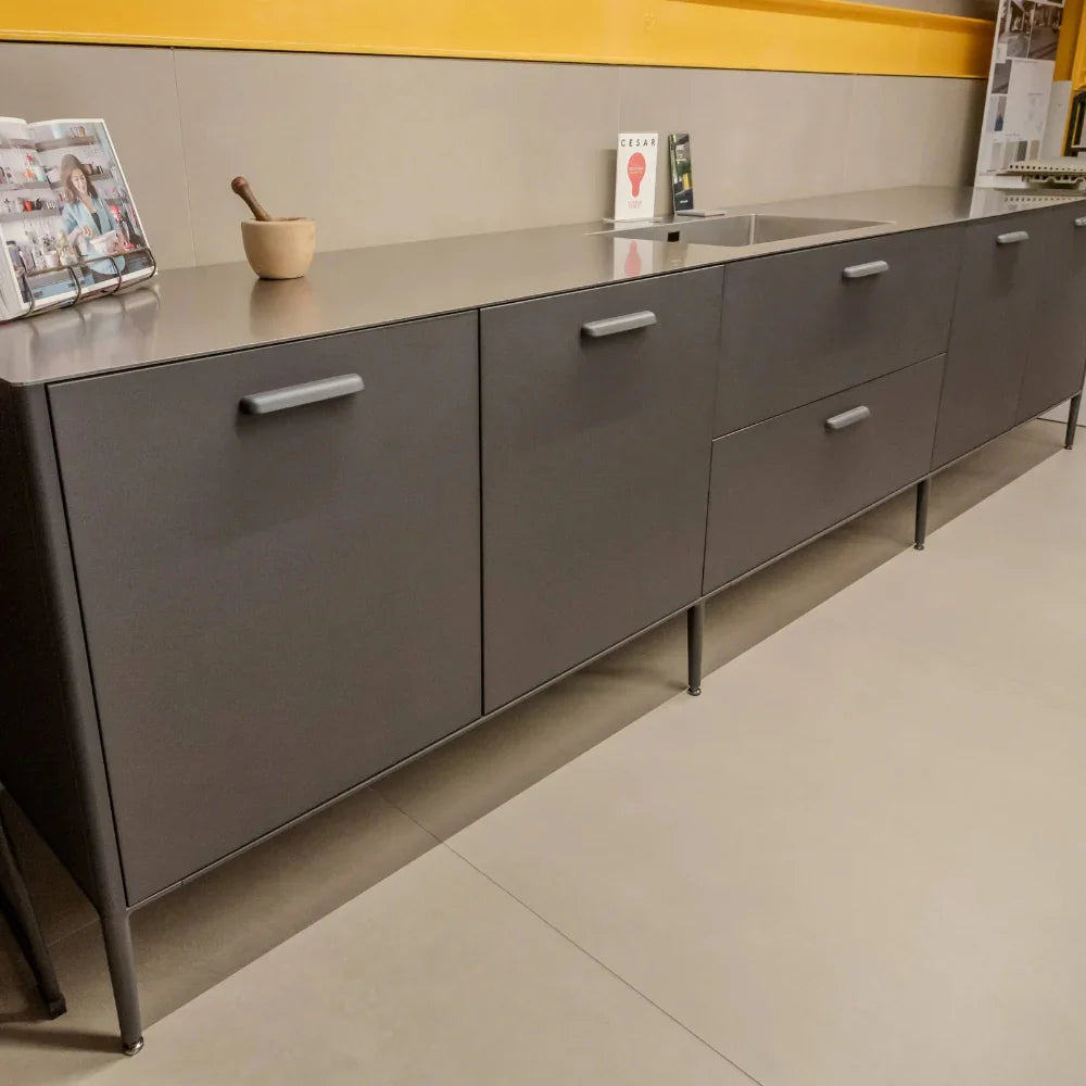 Grey kitchen cabinet with a countertop in a modern kitchen setting