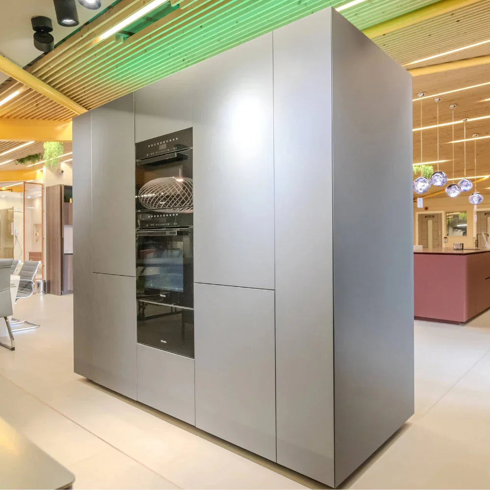 Modern kitchen with a large gray cabinet featuring built-in appliances.