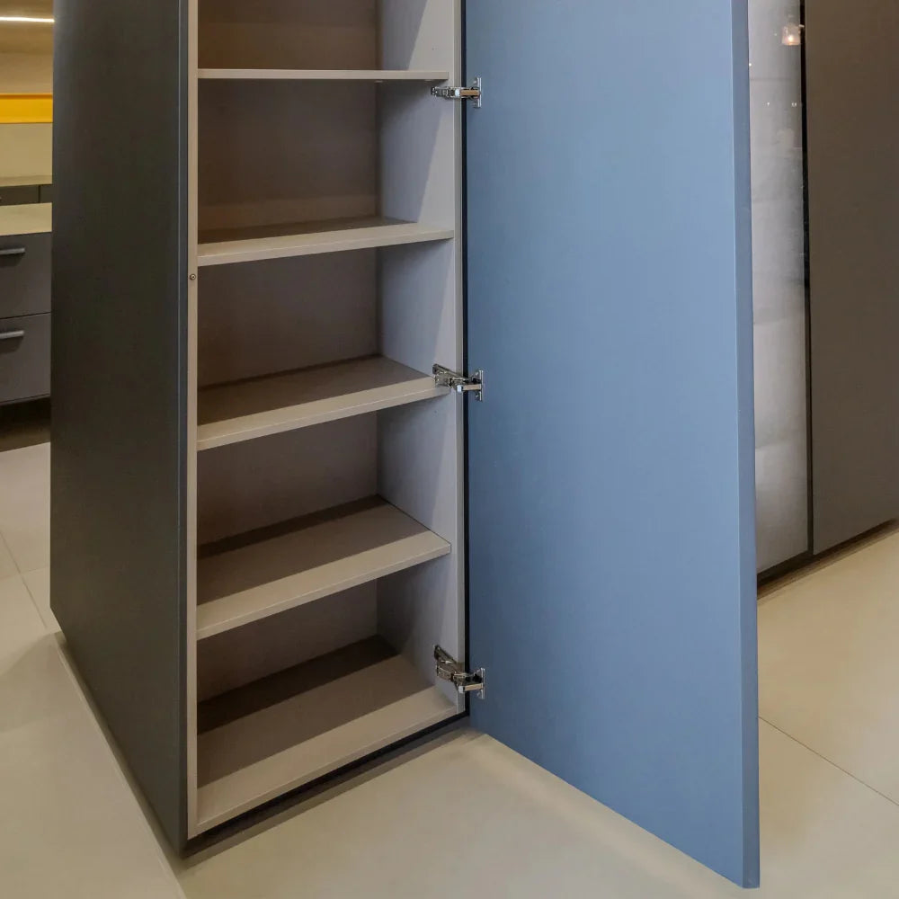 Cabinet with open door revealing empty shelves in a kitchen setting.