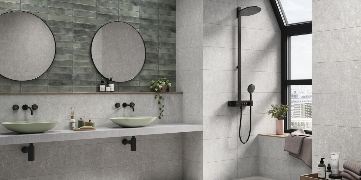 grey stone effect bathroom tiles and green subway wall tiles in a modern bathroom with a city view 