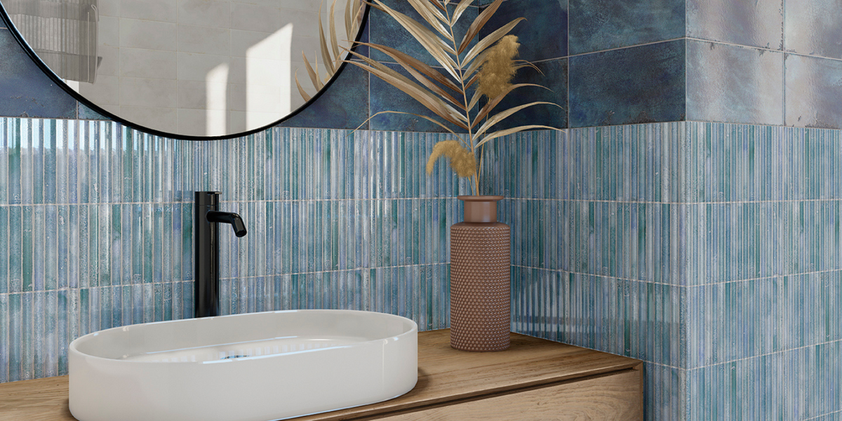 blue kitkat tiles along with blue tiles on wall in a bathroom 