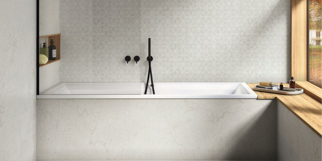 Simple sleek bathroom with built in bathtub, light grey wall tiles and black fixtures