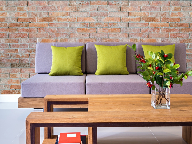 Modern interior Living room with sofa, flower vase and brick wall background