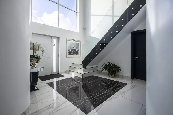 Black and white tiled flooring in an elegant hallway