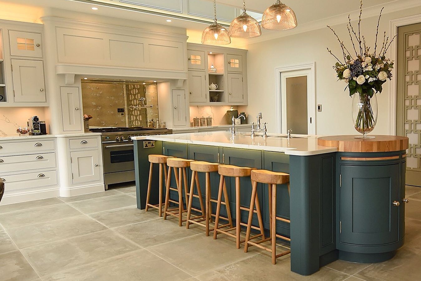 Beautiful country house kitchen with wood detailing and blue cabinets