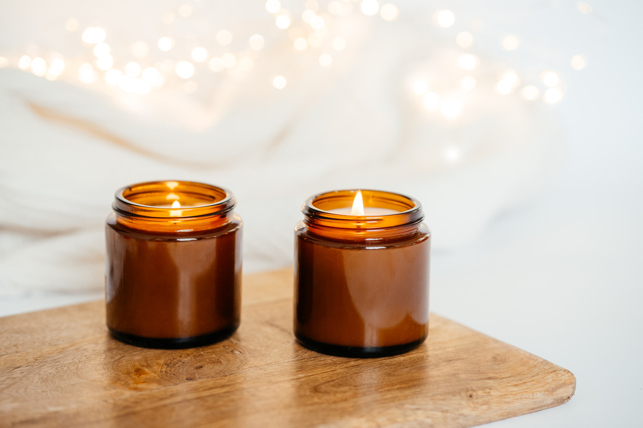 Beautiful cosy candles next to a bubble bath