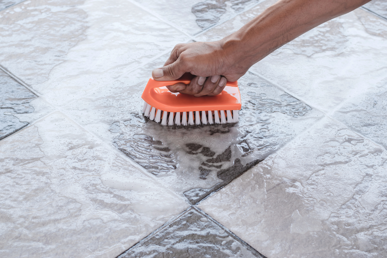 Scrubbing tiles with soap and hot water