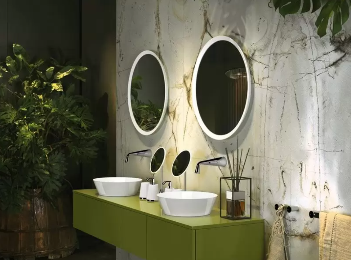His and hers green sinks with plants and marble effect tiles