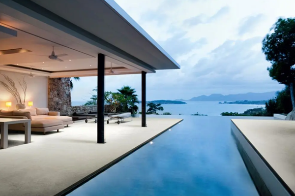 Outdoor tiles on a stunning holiday home patio with infinity pool looking out to sea