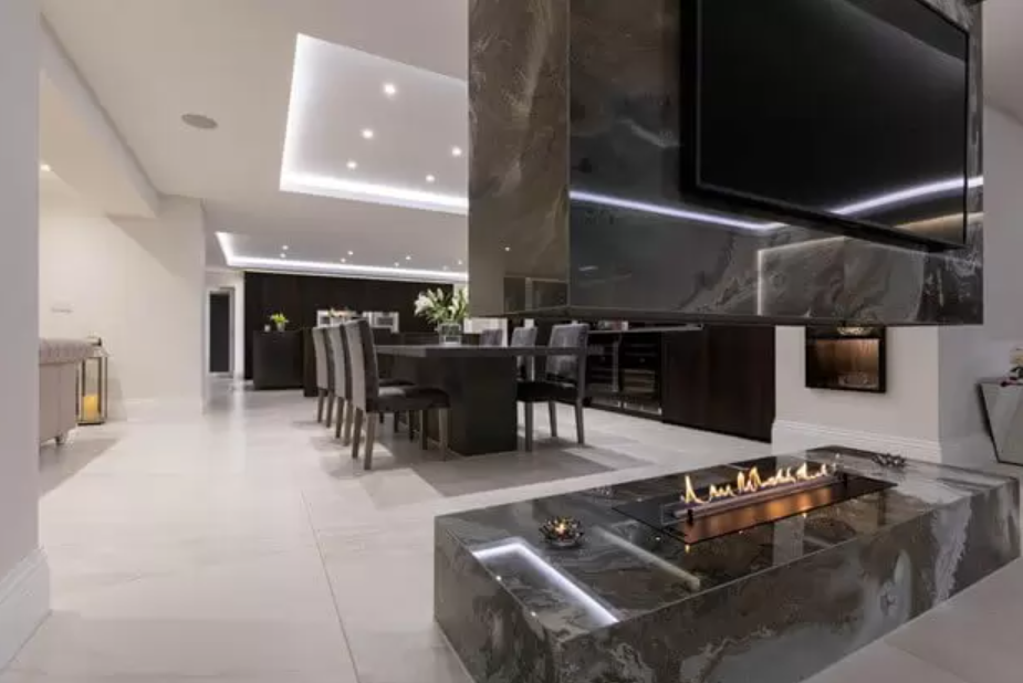 Stunning Planika fireplace surrounded by Roccia's marble tiles