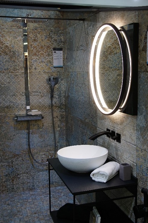 stunning shower and sink area with large LED round mirror