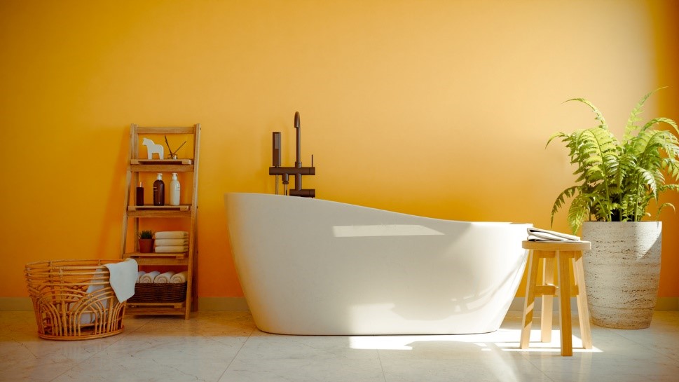 bright yellow bathroom wall with white freestanding tub